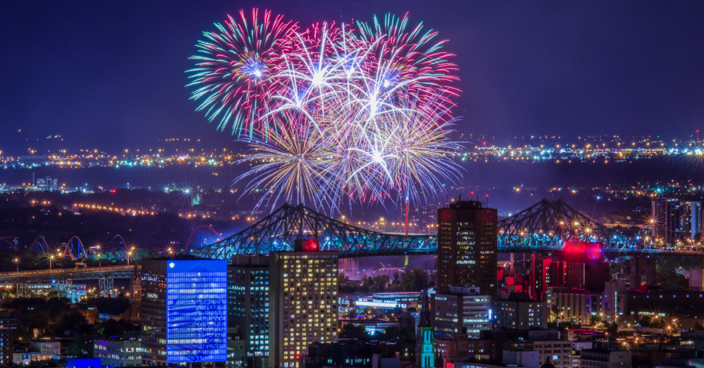 Spectacular night view of Montreal's skyline during the International Jazz Festival with colorful fireworks above the city, reflecting the vibrant culture and festive atmosphere of this annual event.